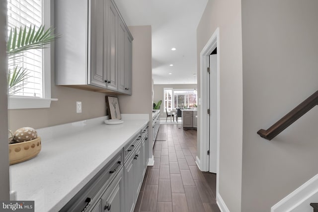 kitchen featuring recessed lighting, gray cabinets, baseboards, and wood finish floors