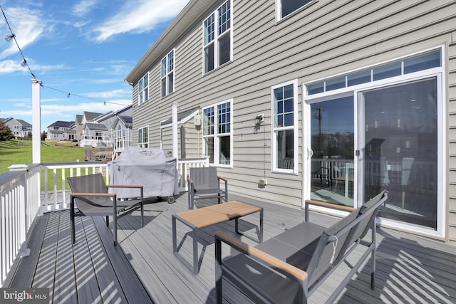 wooden deck featuring grilling area and a residential view