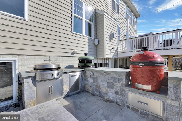 view of patio featuring area for grilling and exterior kitchen