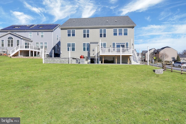 back of house featuring a wooden deck, stairs, and a yard