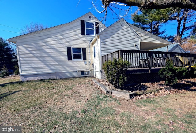 rear view of house featuring a yard and a wooden deck