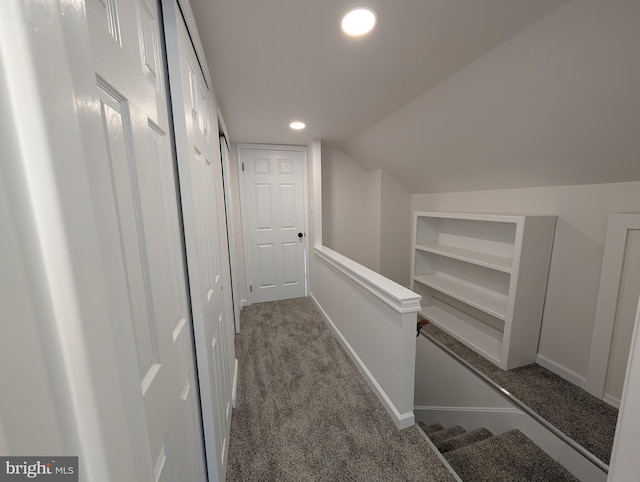 corridor featuring an upstairs landing, built in features, recessed lighting, carpet flooring, and lofted ceiling