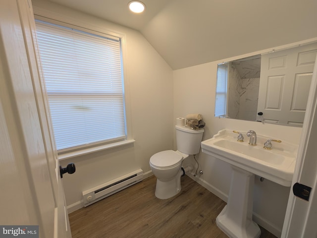 half bathroom featuring wood finished floors, baseboards, vaulted ceiling, a baseboard heating unit, and toilet