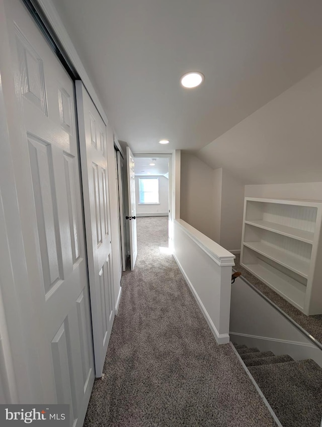 hallway with recessed lighting, carpet, and vaulted ceiling