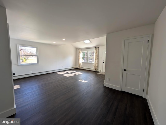 empty room with baseboards, lofted ceiling, recessed lighting, dark wood-type flooring, and baseboard heating