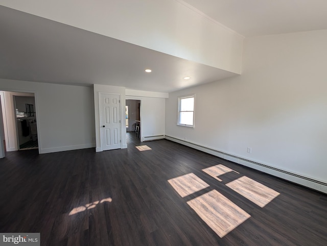 interior space featuring recessed lighting, a baseboard heating unit, dark wood-type flooring, and baseboards