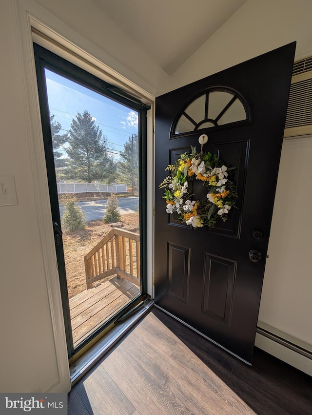 foyer entrance featuring lofted ceiling, dark wood-type flooring, and baseboard heating