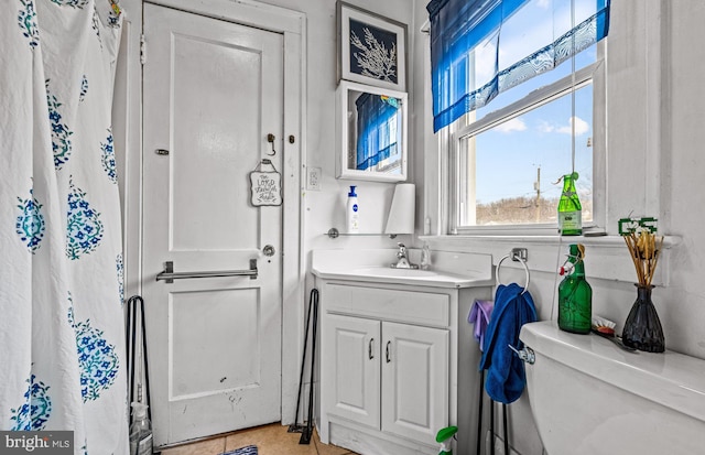 bathroom featuring toilet and vanity