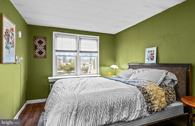 bedroom featuring wood finished floors and baseboards