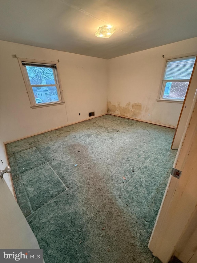 unfurnished bedroom featuring visible vents and carpet floors