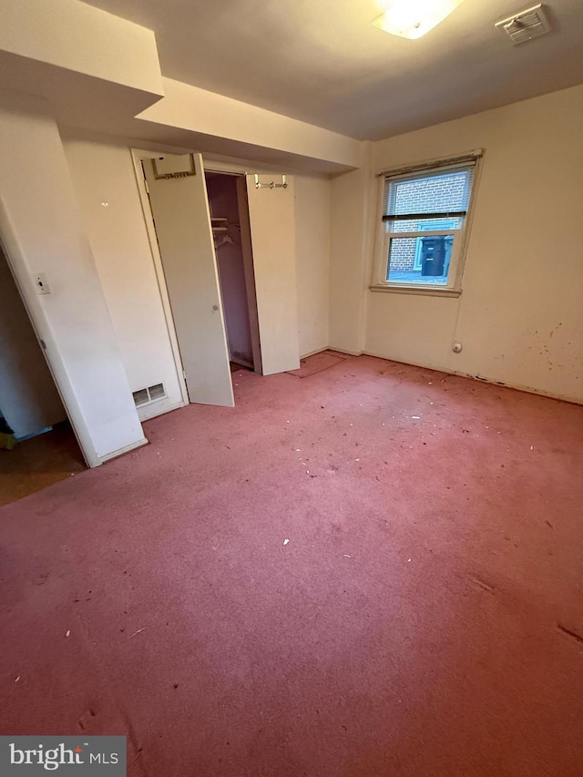 unfurnished room with visible vents and light colored carpet