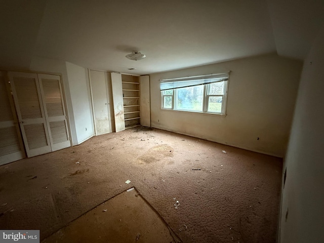 unfurnished bedroom with multiple closets