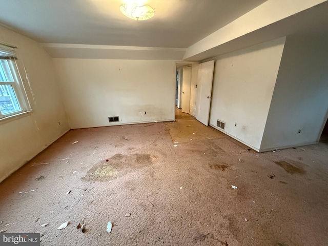 unfurnished room featuring visible vents