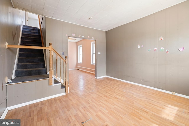 interior space featuring baseboards and wood finished floors