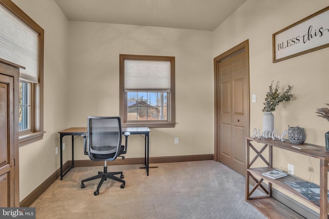 office space with carpet flooring, a healthy amount of sunlight, and baseboards