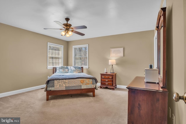 bedroom featuring light colored carpet, baseboards, and ceiling fan