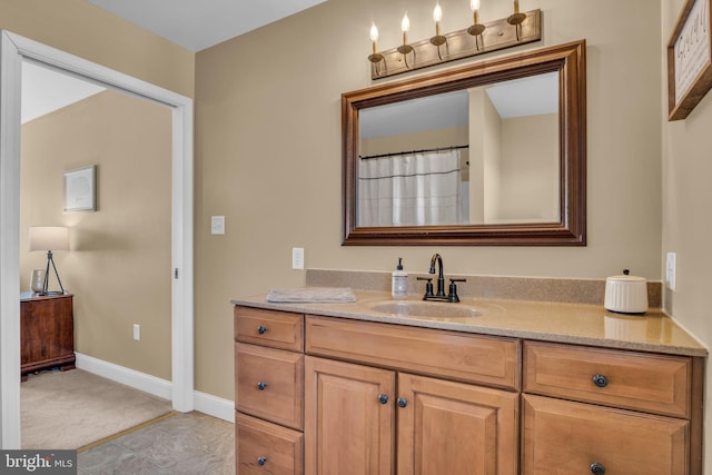 full bathroom with tile patterned floors, baseboards, and vanity