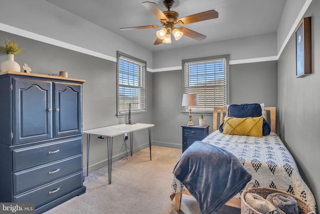 bedroom with baseboards, light carpet, and a ceiling fan