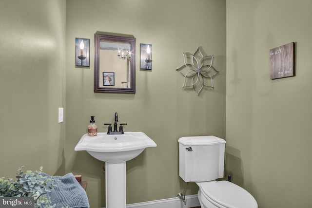 bathroom featuring toilet and baseboards