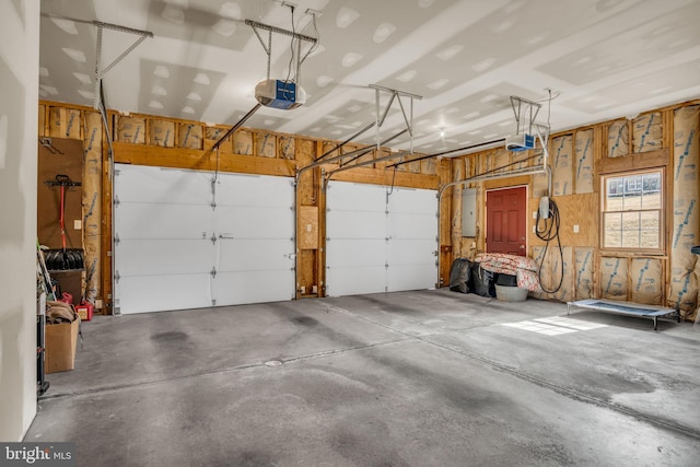 garage featuring electric panel and a garage door opener