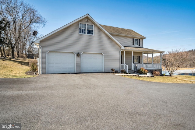 view of front of home with aphalt driveway, covered porch, a shingled roof, and a front lawn