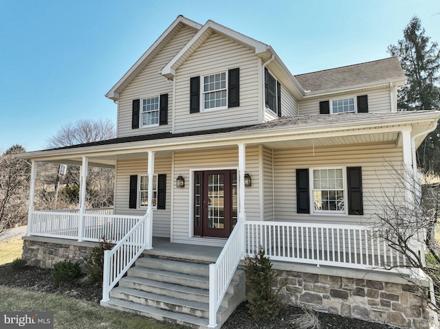 view of front of home with a porch and a shingled roof