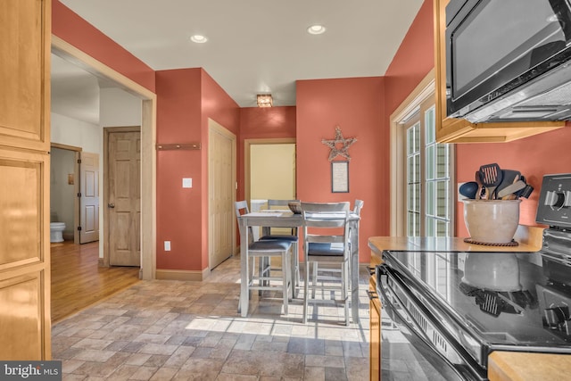 dining room featuring recessed lighting and baseboards