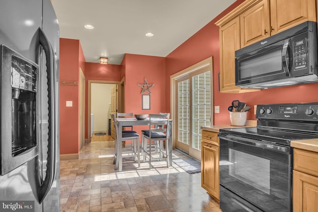 kitchen with recessed lighting, black appliances, light brown cabinets, and light countertops