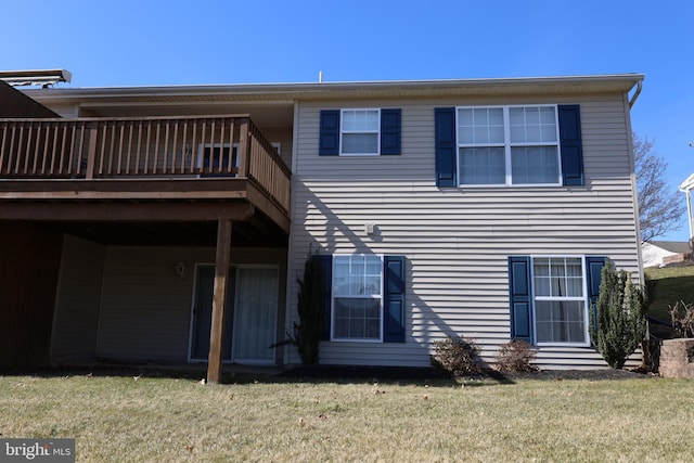 rear view of house with a lawn and a deck