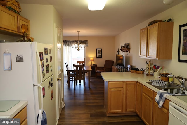 kitchen featuring a sink, white appliances, a peninsula, and light countertops