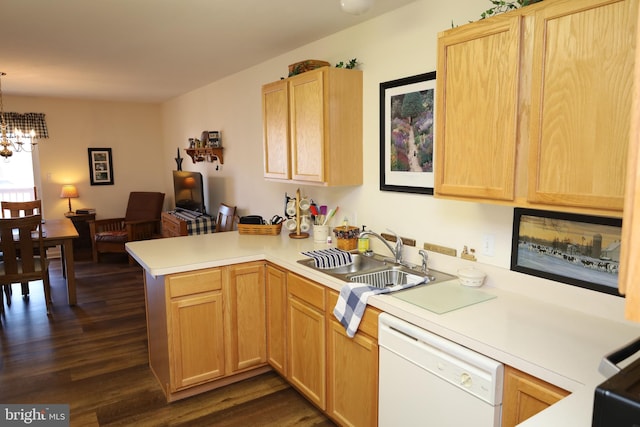 kitchen with dishwasher, a peninsula, light brown cabinets, and a sink