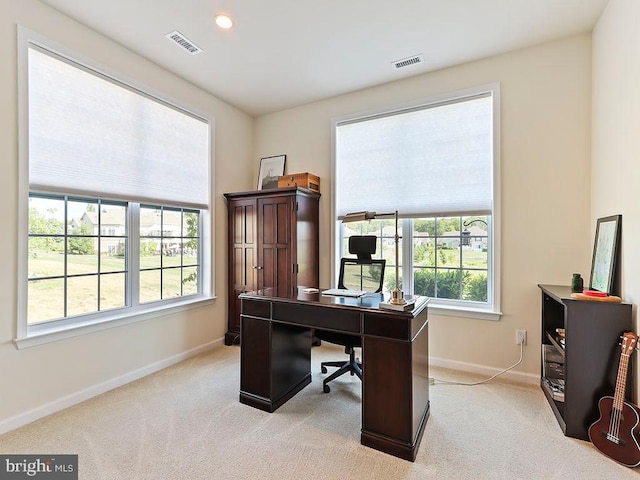 office space featuring light carpet, visible vents, recessed lighting, and baseboards