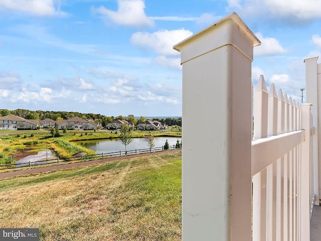 property view of water featuring fence