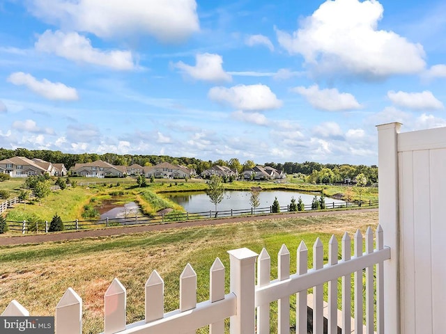 water view with fence and a residential view