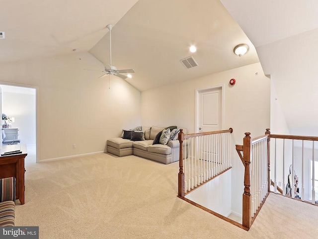 carpeted living room with visible vents, ceiling fan, baseboards, and vaulted ceiling