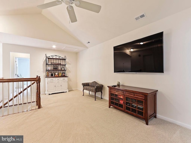 living area with carpet, visible vents, baseboards, lofted ceiling, and an upstairs landing