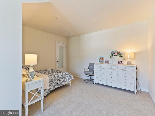 bedroom with baseboards and light carpet