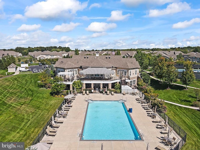 pool with a patio, stairway, fence, a lawn, and a residential view