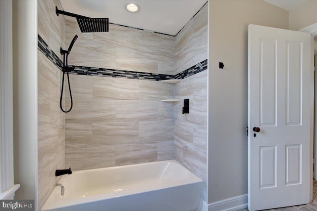 full bath featuring baseboards and bathing tub / shower combination