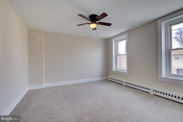 empty room featuring carpet, baseboards, baseboard heating, and ceiling fan