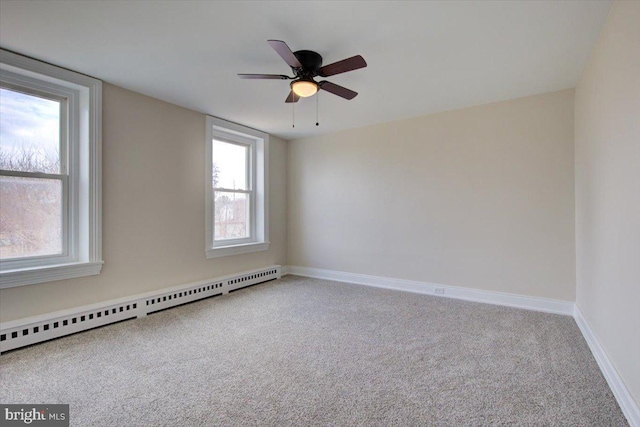 unfurnished room featuring a ceiling fan, baseboards, baseboard heating, and carpet floors