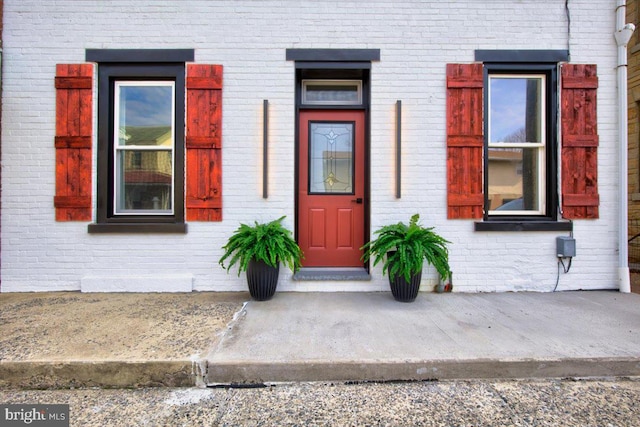 property entrance with brick siding