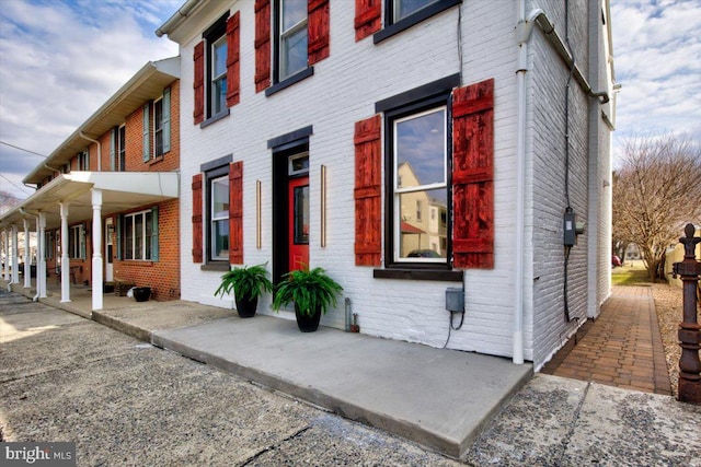 view of side of property featuring brick siding