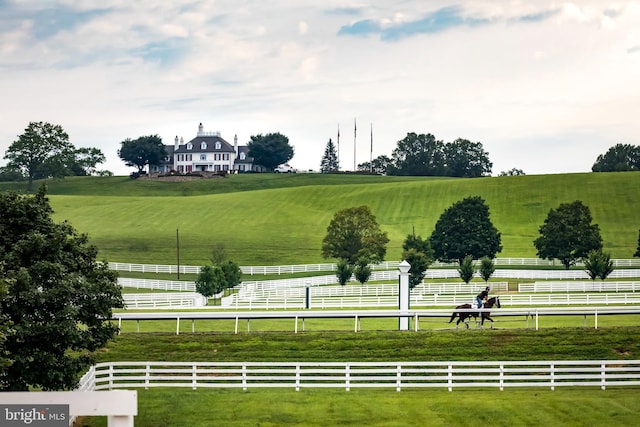 surrounding community featuring a rural view and fence