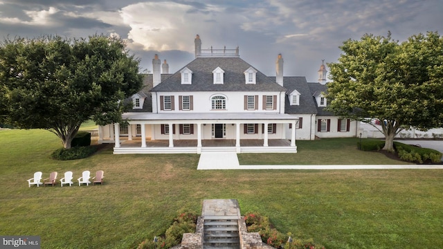 view of front facade with covered porch and a front lawn