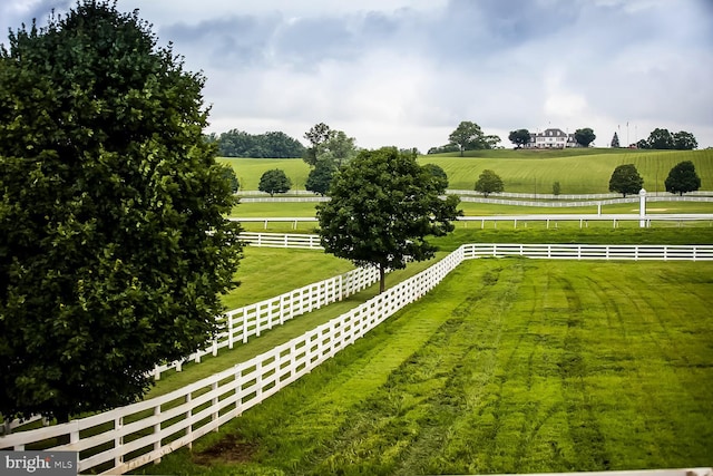 view of yard featuring a rural view and fence