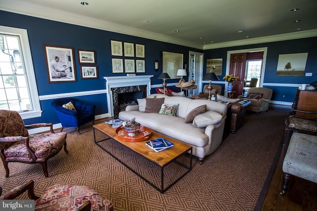 living room with a premium fireplace, plenty of natural light, baseboards, and crown molding