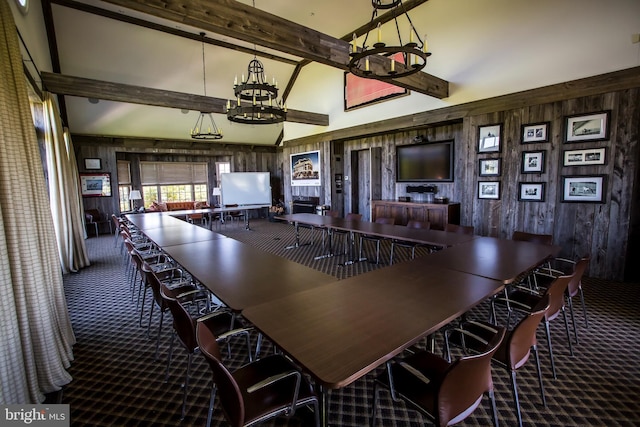 carpeted dining area with an inviting chandelier, wooden walls, beamed ceiling, and high vaulted ceiling