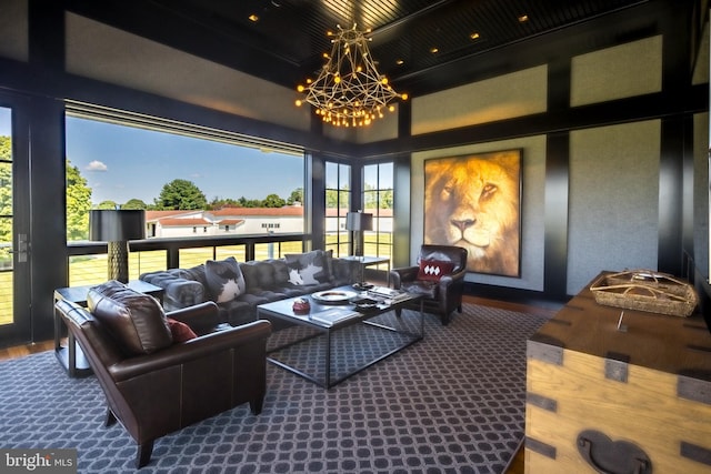 living area featuring an inviting chandelier and wood finished floors