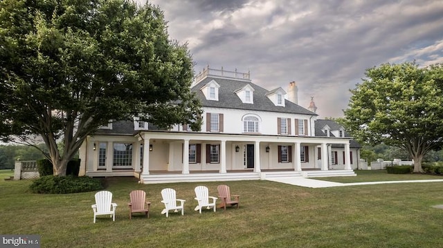 view of front of property with a porch and a front lawn